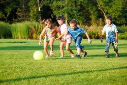 Four preschool kids playing with the ball