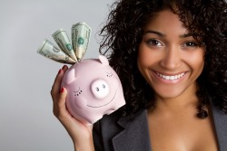 African american woman holding piggy bank